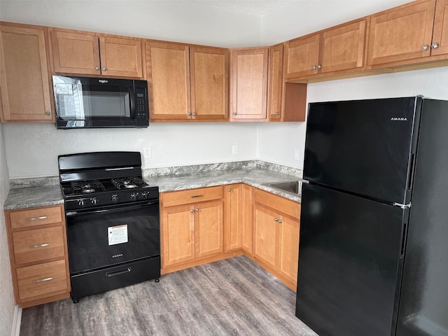 kitchen featuring light wood-style flooring and black appliances