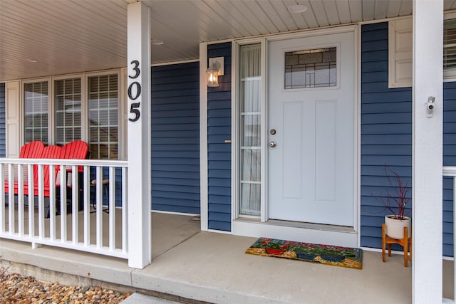 view of exterior entry with a porch