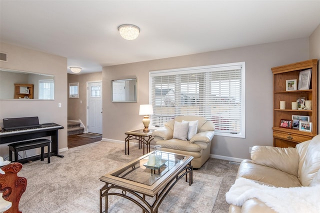 living room with stairway, baseboards, visible vents, and carpet floors