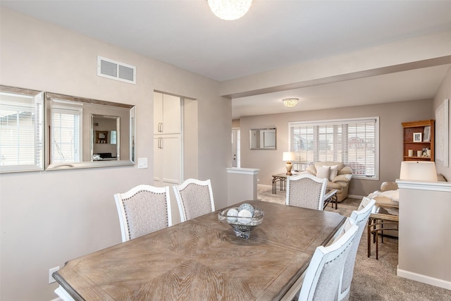 dining space featuring baseboards, visible vents, and carpet floors