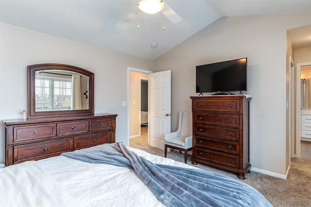 carpeted bedroom with vaulted ceiling, baseboards, and ceiling fan