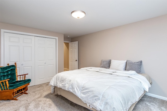 carpeted bedroom featuring a closet and baseboards