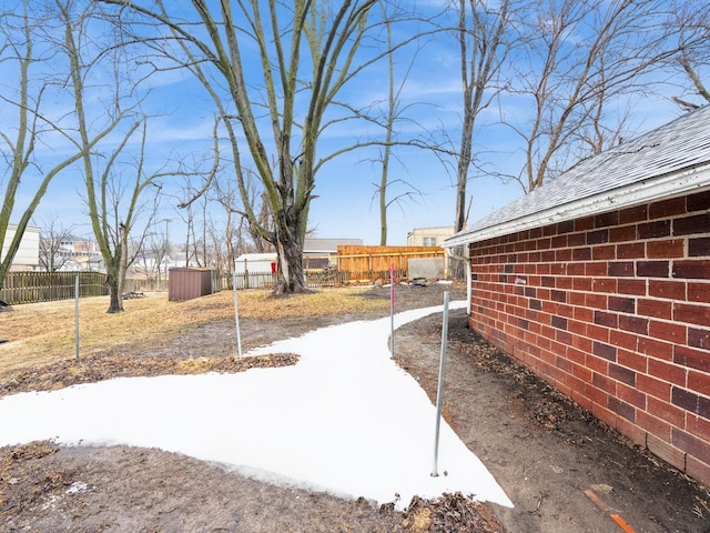 view of yard featuring an outbuilding and fence