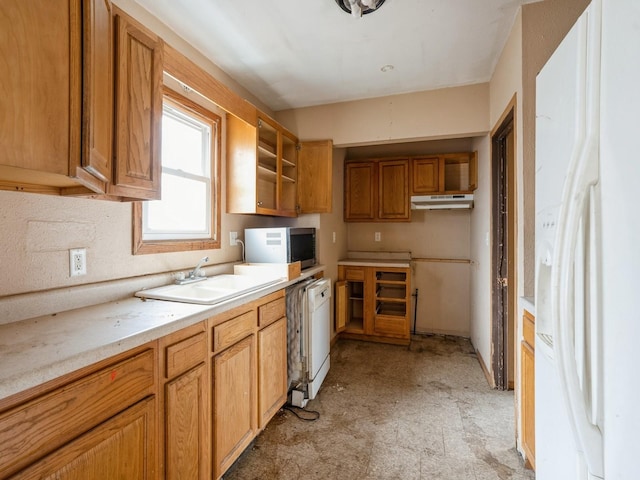 kitchen featuring white appliances, open shelves, a sink, light countertops, and under cabinet range hood