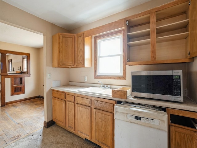 kitchen featuring stainless steel microwave, a sink, open shelves, and white dishwasher