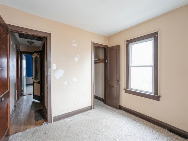 unfurnished bedroom with baseboards and a closet