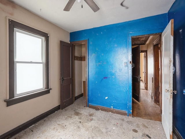 unfurnished bedroom featuring ceiling fan and baseboards