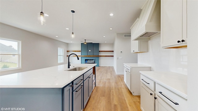 202 Meadowlark Dr, Monroe, IA 50170 - kitchen with a sink, light wood-type flooring, plenty of natural light, premium range hood, and recessed lighting