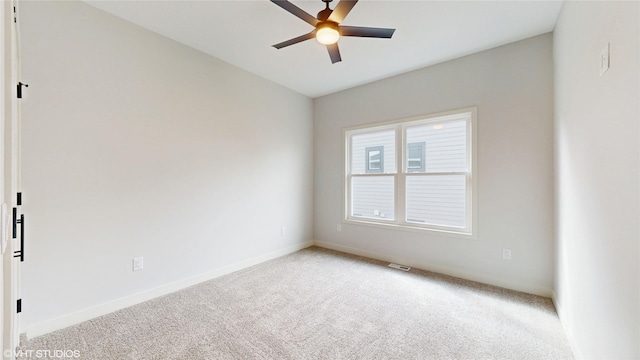202 Meadowlark Dr, Monroe, IA 50170 - spare room featuring carpet flooring, ceiling fan, and baseboards