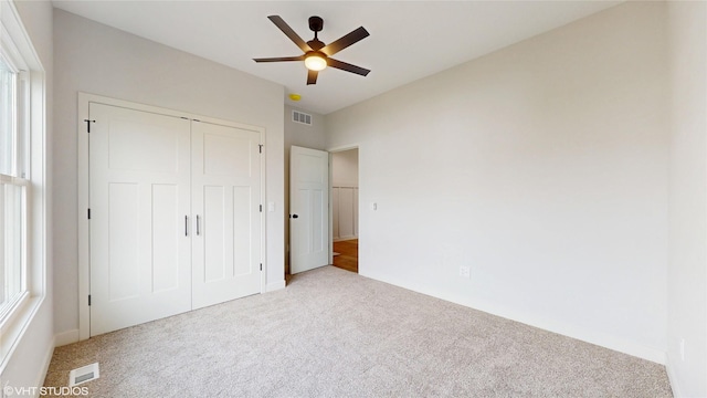 202 Meadowlark Dr, Monroe, IA 50170 - unfurnished bedroom featuring carpet, a closet, and a ceiling fan