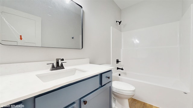 202 Meadowlark Dr, Monroe, IA 50170 - full bathroom featuring toilet, vanity, wood finished floors, and shower / bath combination
