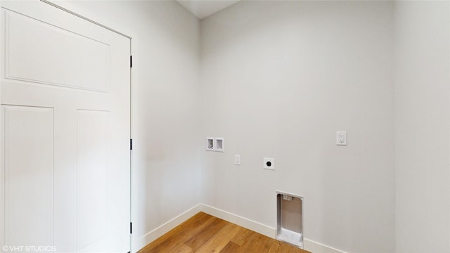 202 Meadowlark Dr, Monroe, IA 50170 - washroom featuring washer hookup, electric dryer hookup, light wood-type flooring, and baseboards