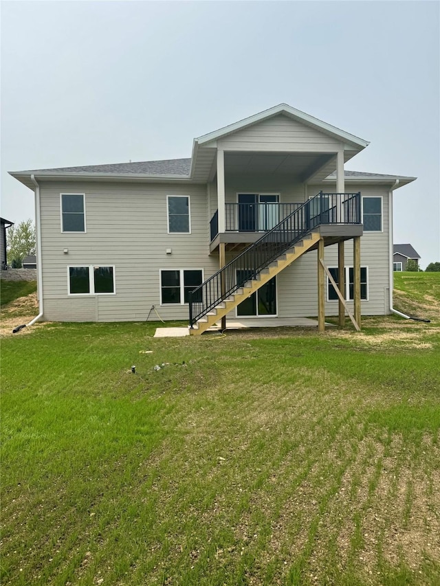 202 Meadowlark Dr, Monroe, IA 50170 - rear view of house with stairway, a lawn, and a wooden deck