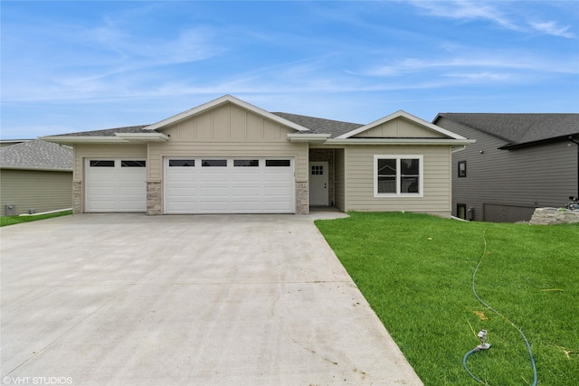 202 Meadowlark Dr, Monroe, IA 50170 - ranch-style house featuring board and batten siding, a garage, a front lawn, and driveway