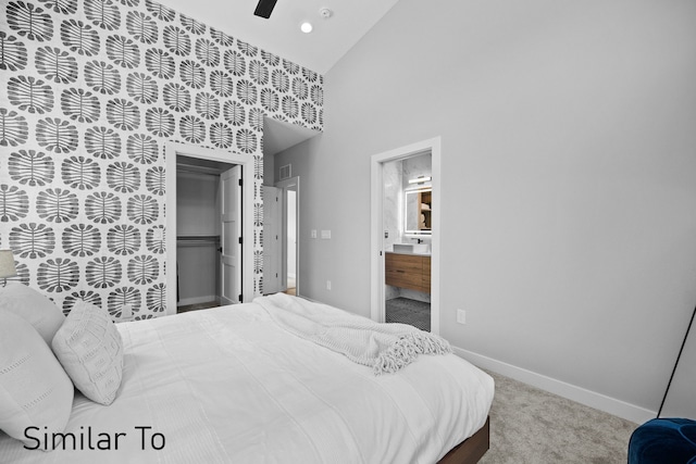 4828 Ingersoll Ave, Des Moines, IA 50312 - bedroom featuring carpet, baseboards, high vaulted ceiling, ensuite bath, and a closet