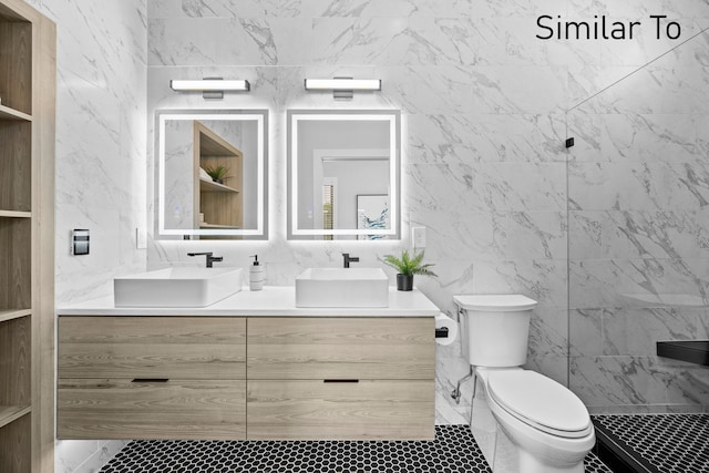 4828 Ingersoll Ave, Des Moines, IA 50312 - bathroom featuring tiled shower, toilet, and a sink