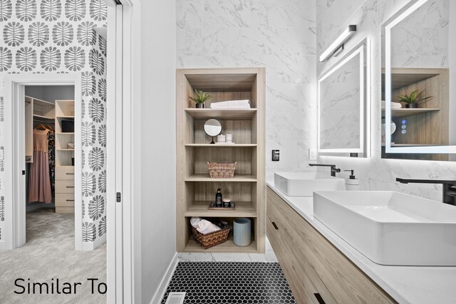 4828 Ingersoll Ave, Des Moines, IA 50312 - bathroom with a sink, a walk in closet, built in shelves, and double vanity