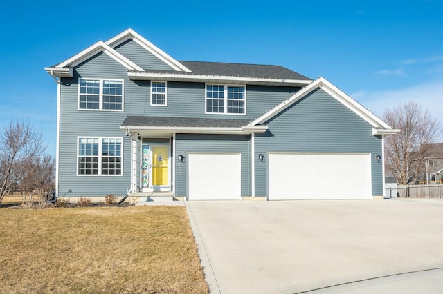 traditional-style home with driveway, a shingled roof, and a front yard