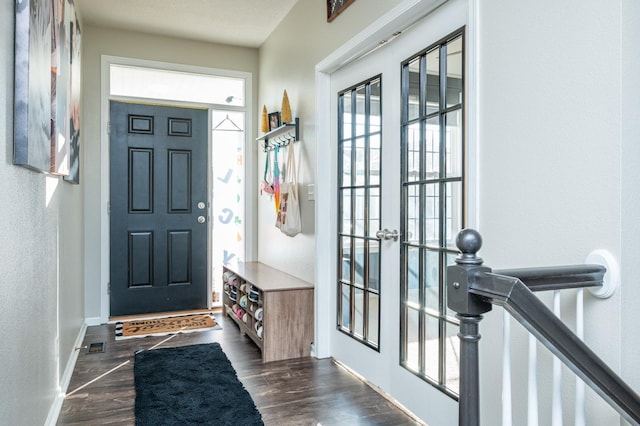 mudroom featuring baseboards and dark wood-style flooring