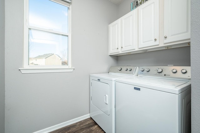 laundry room with dark wood finished floors, cabinet space, baseboards, and washing machine and clothes dryer