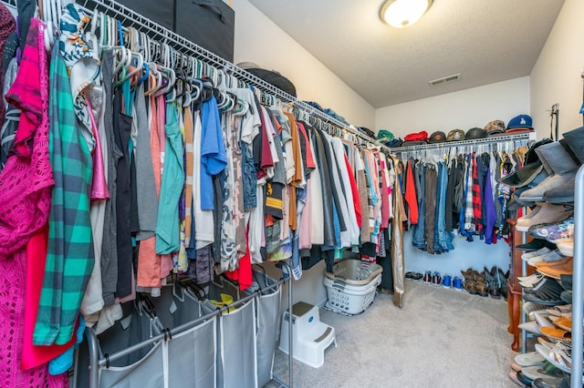 spacious closet featuring visible vents and carpet flooring