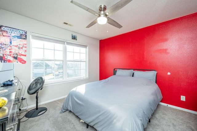 bedroom with visible vents, baseboards, carpet, and a ceiling fan