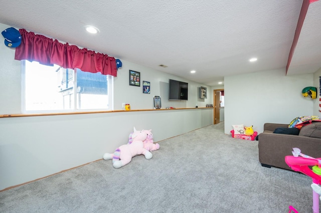 rec room with carpet flooring, recessed lighting, and a textured ceiling