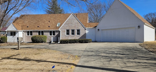 view of front of property featuring aphalt driveway, a garage, and brick siding