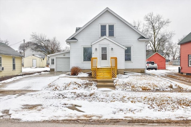 bungalow with a detached garage and an outbuilding