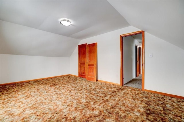 bonus room with vaulted ceiling, baseboards, and carpet floors