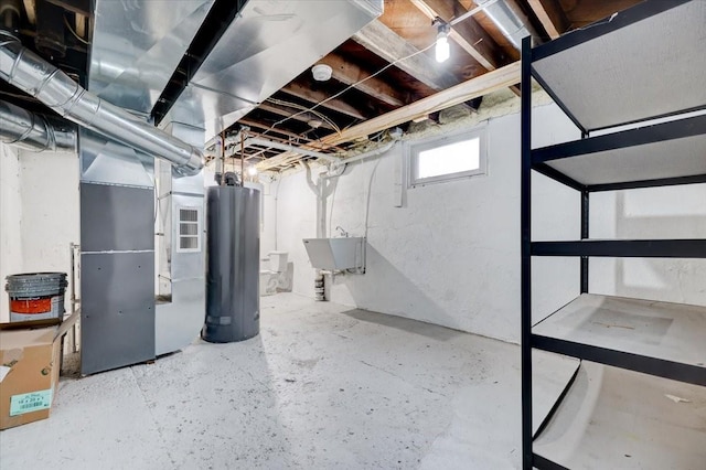 basement featuring a sink, heating unit, and water heater