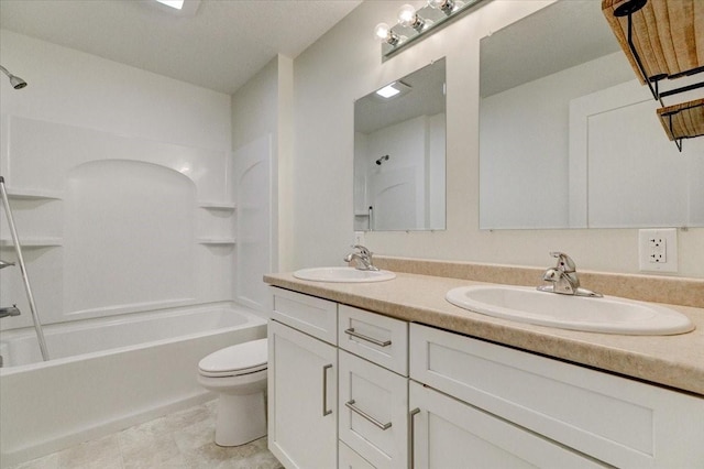 bathroom featuring double vanity, toilet, washtub / shower combination, and a sink