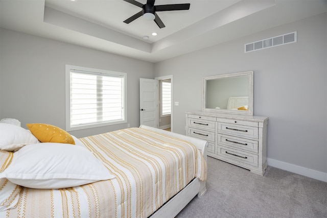 5015 149th Ct, Urbandale, IA 50323 - bedroom with a tray ceiling, light colored carpet, recessed lighting, and ceiling fan
