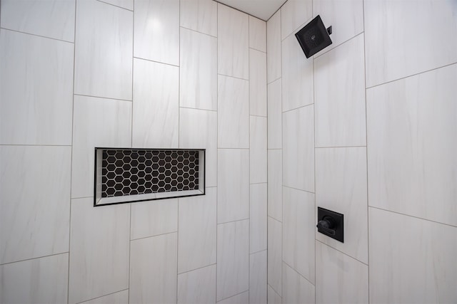 interior details with a tile shower