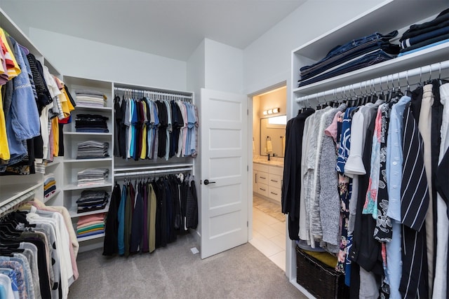 spacious closet featuring tile patterned flooring and carpet flooring