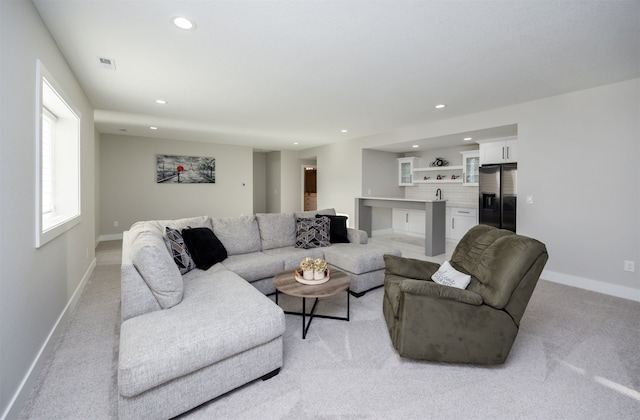 living area featuring light carpet, visible vents, recessed lighting, and baseboards