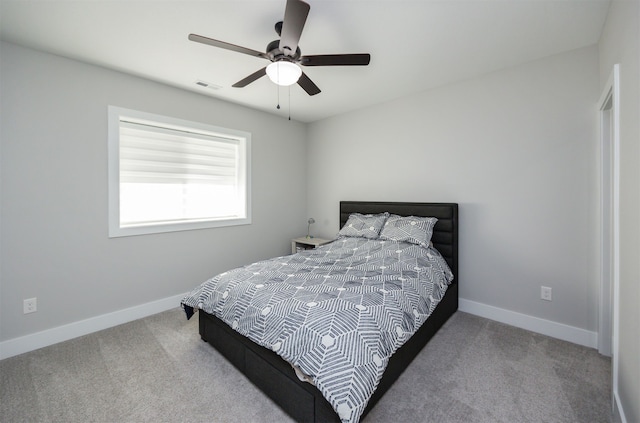 bedroom with a ceiling fan, baseboards, visible vents, and carpet floors