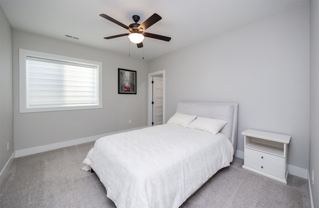 bedroom featuring baseboards, visible vents, carpet floors, and ceiling fan