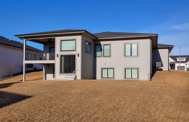 back of house with a balcony, a yard, and ceiling fan