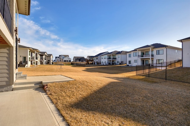 view of yard with a residential view and fence