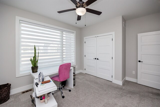 carpeted office space with visible vents, ceiling fan, and baseboards