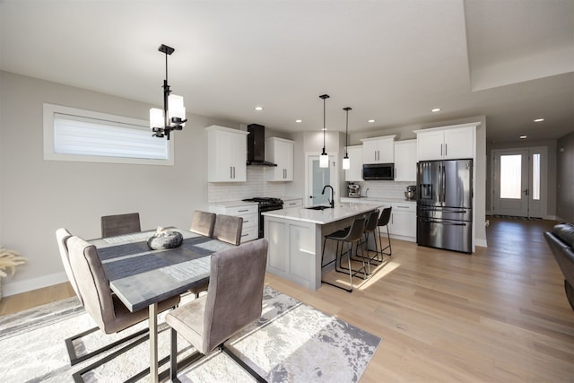 dining room with recessed lighting, light wood-type flooring, and baseboards