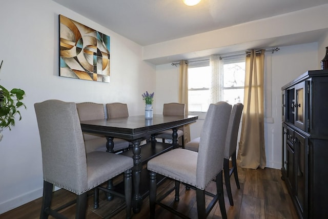 dining area with dark wood finished floors and baseboards