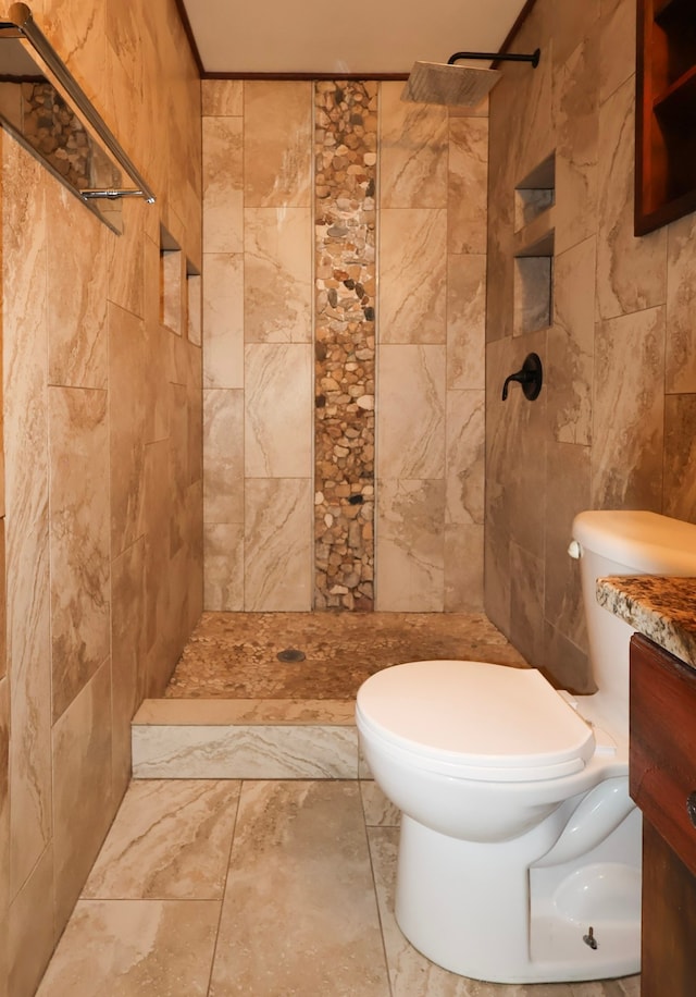 bathroom with tile walls, toilet, and tiled shower