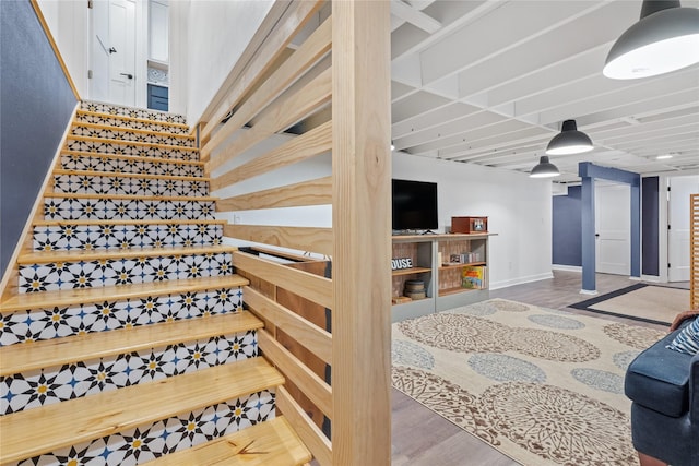 stairway with baseboards and wood finished floors