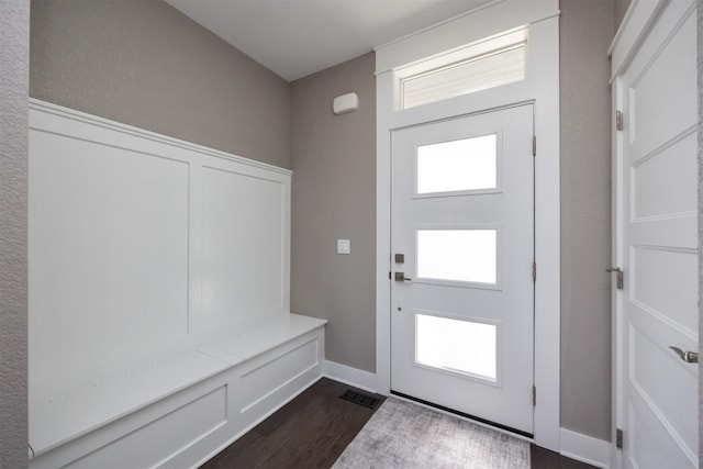 mudroom featuring dark wood-type flooring, a healthy amount of sunlight, baseboards, and visible vents