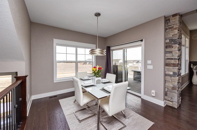 dining room with a wealth of natural light, visible vents, baseboards, and dark wood-style floors