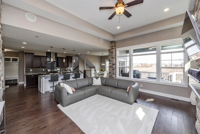 living room featuring visible vents, baseboards, dark wood finished floors, recessed lighting, and a ceiling fan