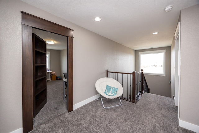 hall with an upstairs landing, recessed lighting, baseboards, and carpet