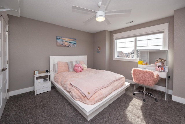 bedroom featuring visible vents, baseboards, a ceiling fan, and dark carpet